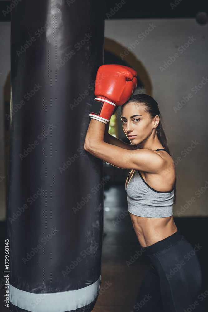 female boxer with punching bag