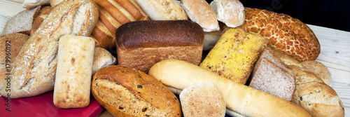 Panorama of different types / variety of bread loaves. photo