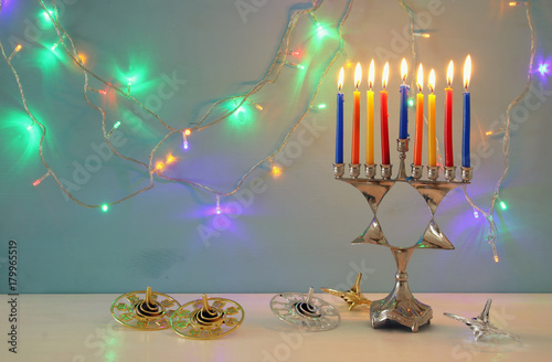 image of jewish holiday Hanukkah background with menorah (traditional candelabra) and burning candles