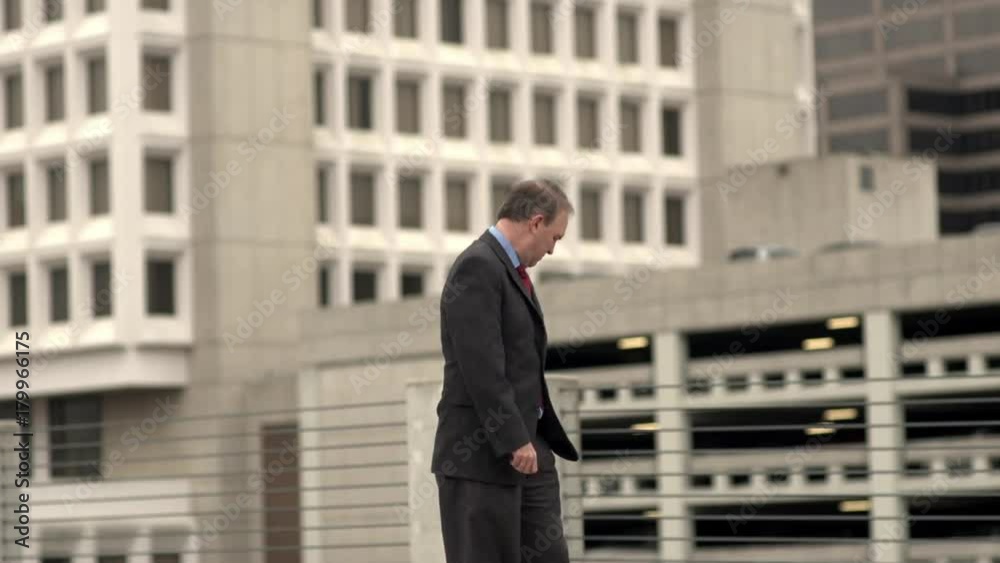 Businessman takes a phonecall outdoors Businessman takes a phonecall outdoors