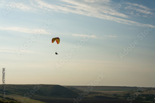 person flying on paraplane