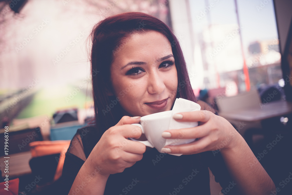 Beautiful girl drinking coffee at the coffee shop Beautiful girl drinking coffee at the coffee shop