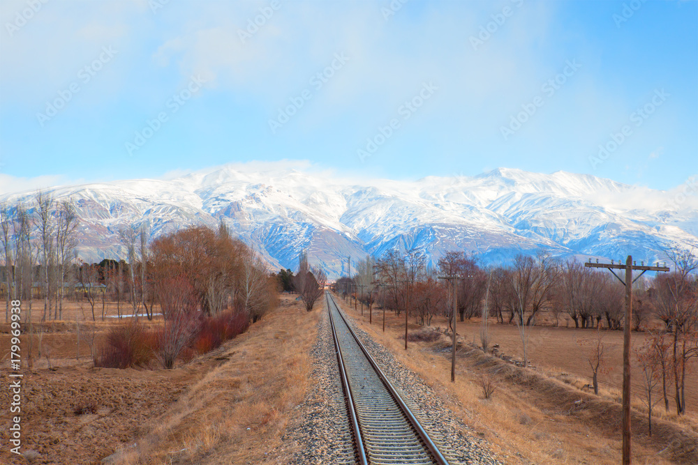 Fototapeta premium Deep Winter Train Tracks and Mountains