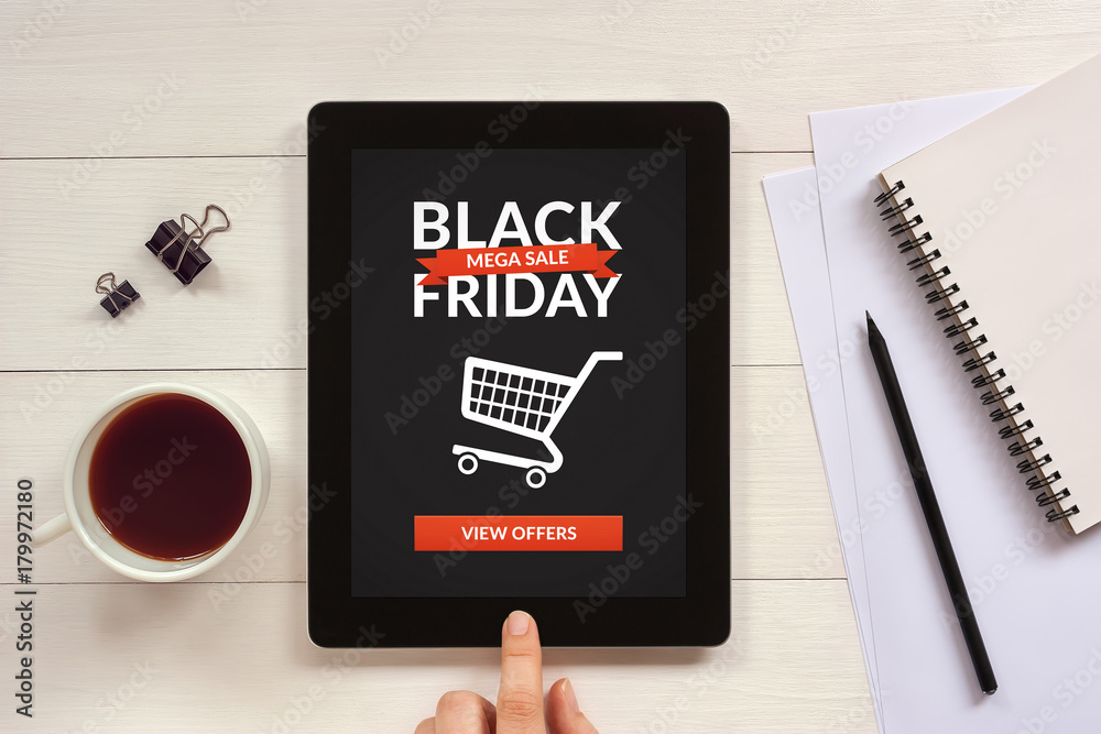Black Friday concept on tablet screen with office objects on white wooden table. All screen content is designed by me. Flat Black Friday concept on tablet screen with office objects on white wooden table. All screen content is designed by me. Flat