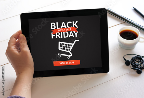 Hand holding digital tablet computer with Black Friday concept on screen. All screen content is designed by me