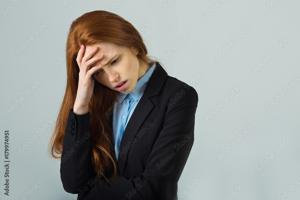 beautiful young girl with red hair in a black jacket on a light background with an emotional expression beautiful young girl with red hair in a black jacket on a light background with an emotional expression