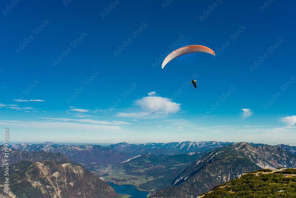 Paraglider flying in blue sky Paraglider flying in blue sky