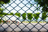 Wire mesh fence on natural background with Transportation trucks.