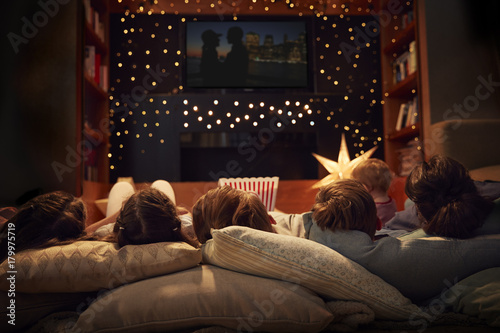 Family Enjoying Movie Night At Home Together