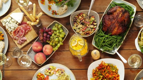group of people eating at table with food