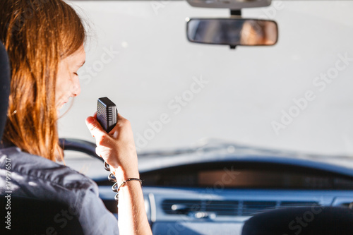 Young man driving car using cb radio photo