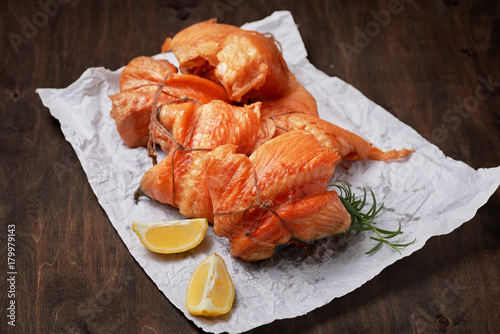 hot smoked salmon fillet rolls on crumpled paper © tananddda