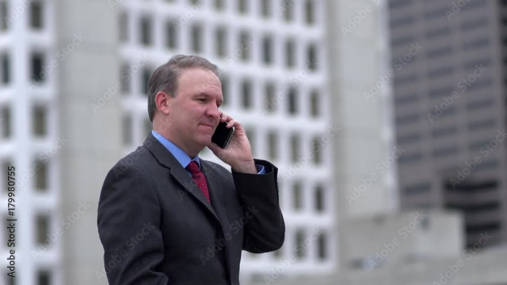 Excited businessman talking on the phone Excited businessman talking on the phone