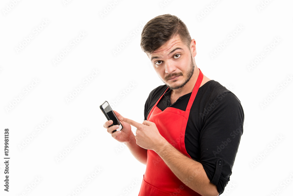 Portrait of male supermarket employer pointing smartphone Portrait of male supermarket employer pointing smartphone