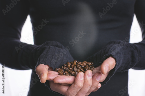 Young man holding coffee in hand