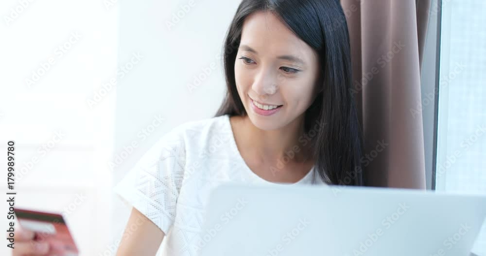Woman use of laptop computer and credit card for online shopping Woman use of laptop computer and credit card for online shopping