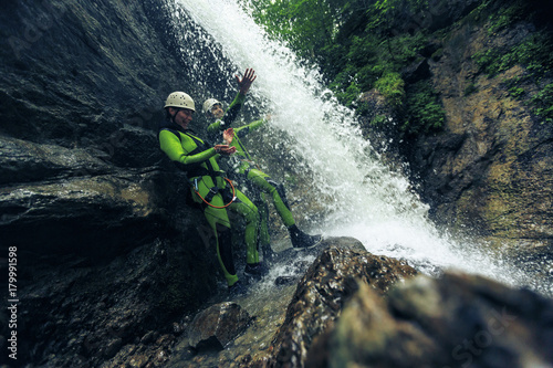 Germany, Bavaria, Allgaeu, young couple canyoning in Ostertal photo