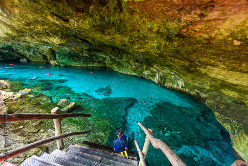 Fototapeta Naklejka Na Ścianę i Meble -  Cenote Dos Ojos in Quintana Roo, Mexico. People swimming and snorkeling in clear blue water. This cenote is located close to Tulum in Yucatan peninsula, Mexico.