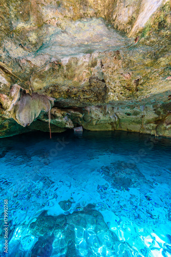 Cenote Dos Ojos in Quintana Roo  Mexico. People swimming and snorkeling in clear blue water. This cenote is located close to Tulum in Yucatan peninsula  Mexico.
