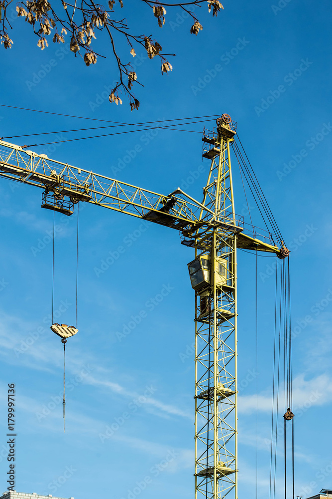 Huge tower crane against sky background
