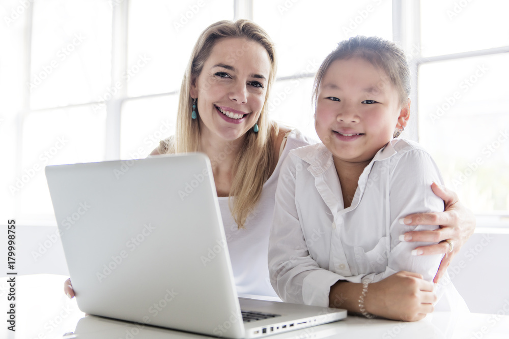 Schoolgirl researching online with the guidance of her teacher Schoolgirl researching online with the guidance of her teacher