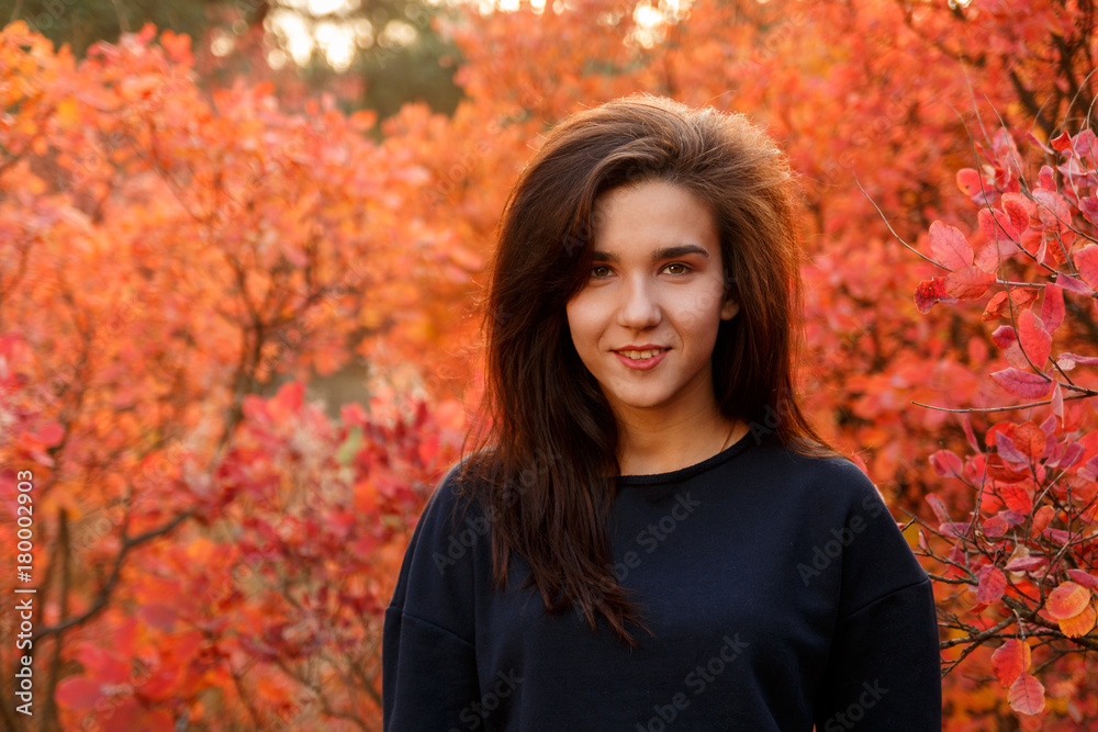 Young girl standing in autumn wood in sportswear Young girl standing in autumn wood in sportswear
