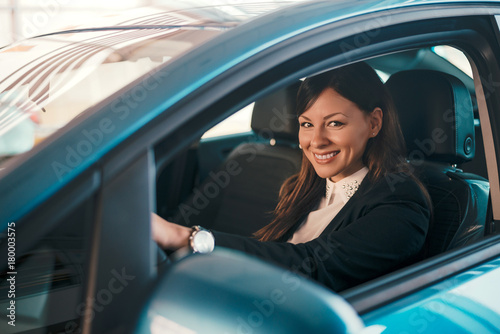 Portrait of woman in car in car salon.
