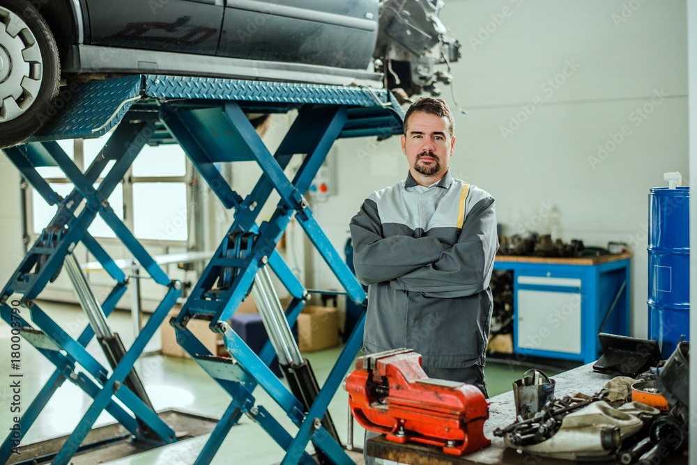 Fototapeta premium Portrait of a mechanic at work in his garage.