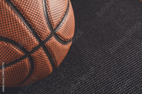Old basketball ball on black background copy space © Prostock-studio