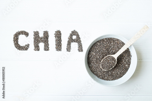 Chia seeds. Chia word made from chia seeds with spoon full of chia in a bowl.
