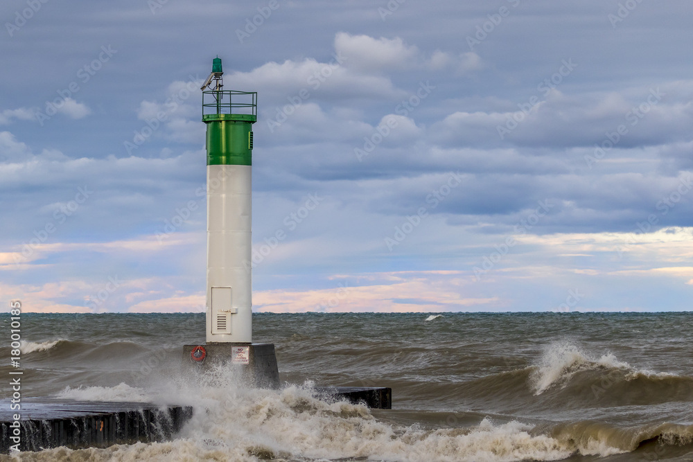 Lighthouse and pier on Lake Huron under a stormy sky - Ontario, Canada