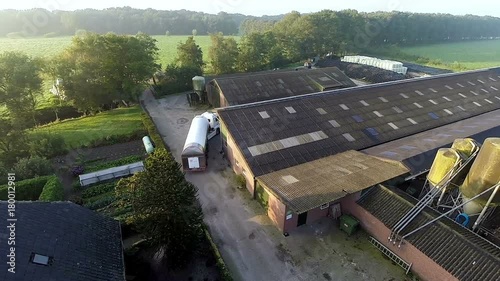 Truck arrives at farm in rural landscape