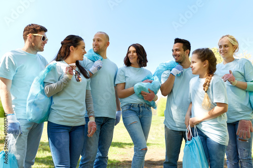 group of volunteers with garbage bags in park