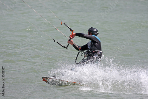 kitesurfer riding his board