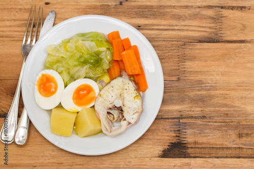 boiled fish with boiled vegetables on white plate photo