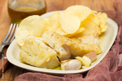 fried codfish with garlic and potato on dish
