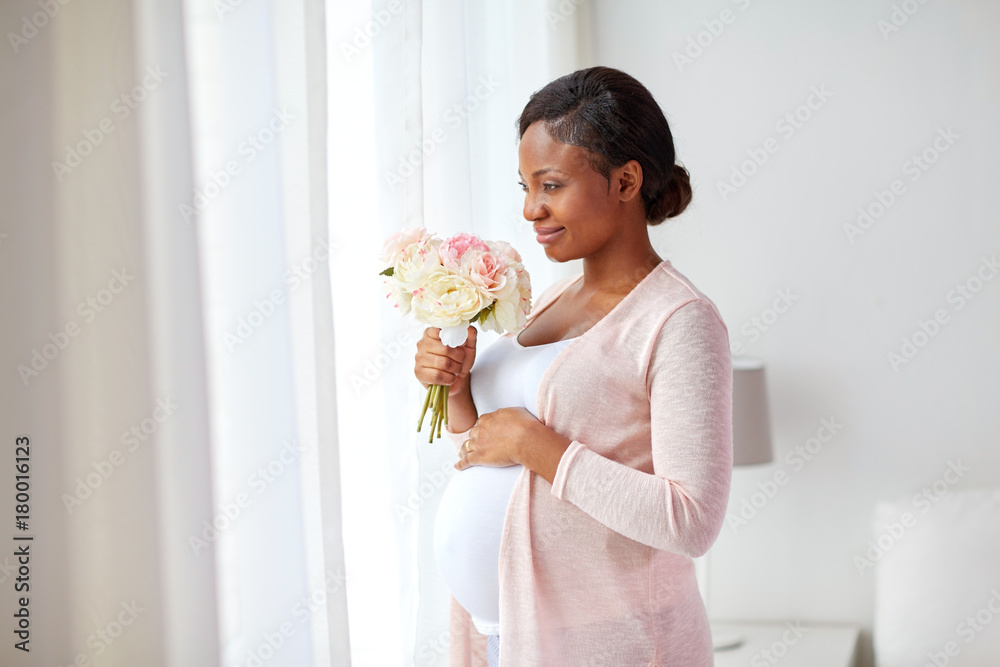 happy african american pregnant woman with flowers happy african american pregnant woman with flowers