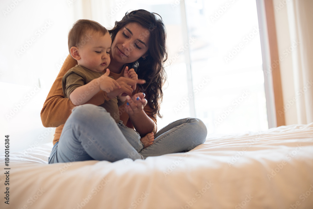 Mother playing with her baby at home