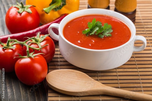 Bowl of gazpacho or tomato soup with ingredients