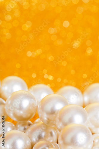 Pile of pearls on golden christmas background