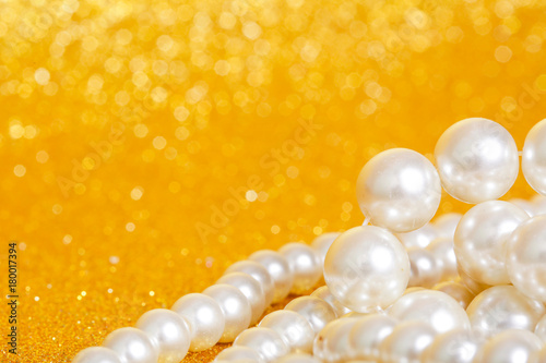 Pile of pearls on golden christmas background