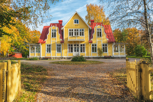 Picture of red wooden scandinavian style house at the lake during autumn photo