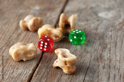 Real dice. Knuckle bones and gaming pieces. Ancient game with lamb bones . photo