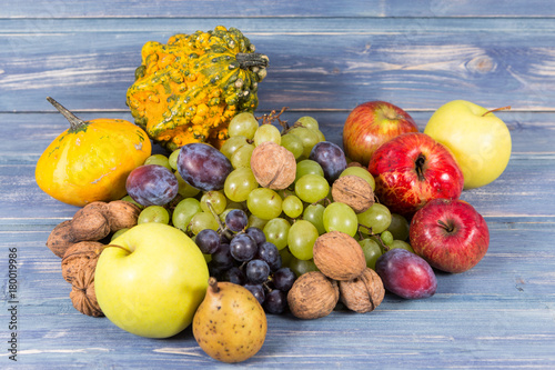 Bunch of autumn fruits on wooden background