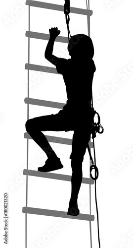 boy in adventure park rope ladder. Silhouette Adventure. Extreme sportsman took down with rope. Sport weekend action in adventure park rope ladder.