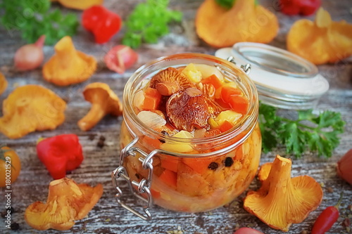 vegetables and mushrooms chanterelles in a glass jar, the preserves in the marinade