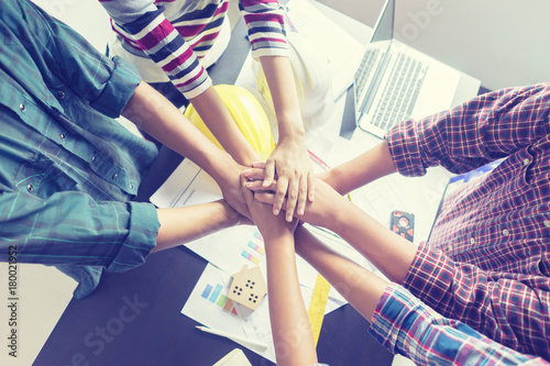 stack hands of business engineering teamwork join together,construction engineer working in construction site, construction engineer conceptual,architect drawing on architectural project on background