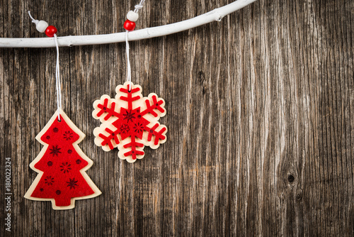 Fototapeta Naklejka Na Ścianę i Meble -  Red Christmas ornaments hanging on wooden branch