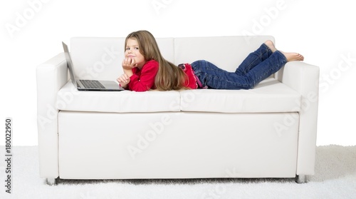 Little Girl Using a Laptop on the Couch