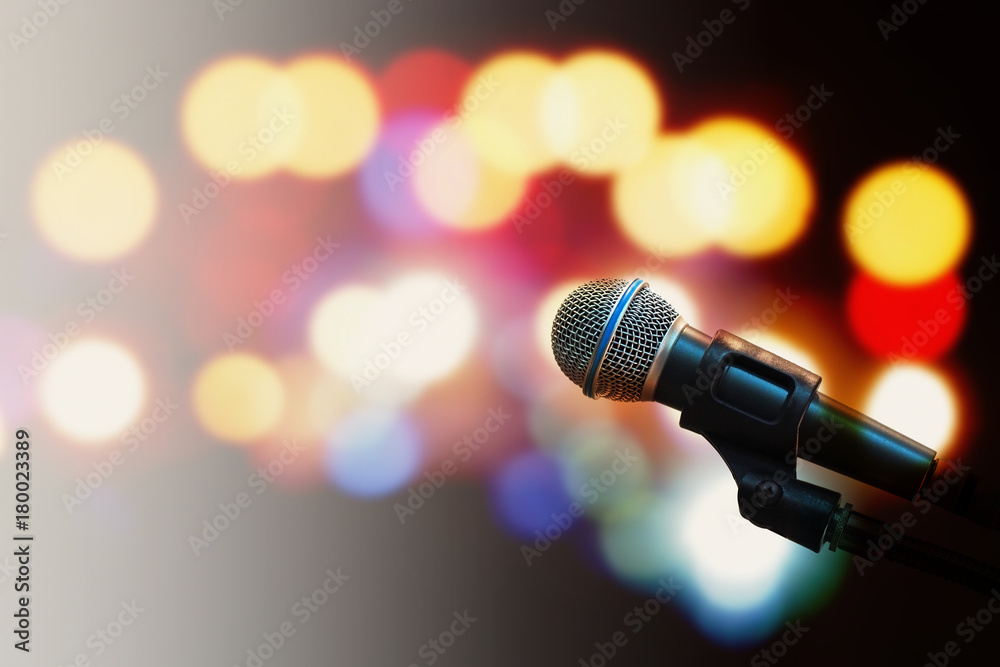Microphone voice speaker on stage with blurred bright light background